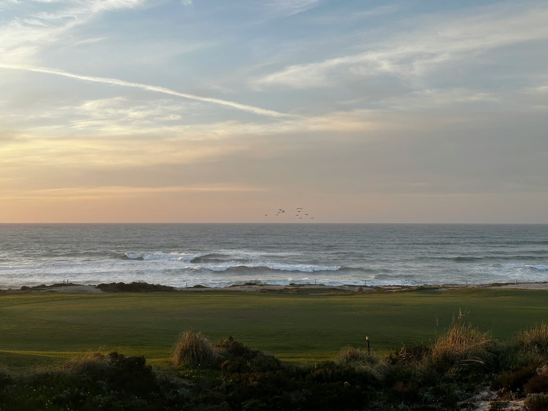 Golf course by the Atlantic at sunset